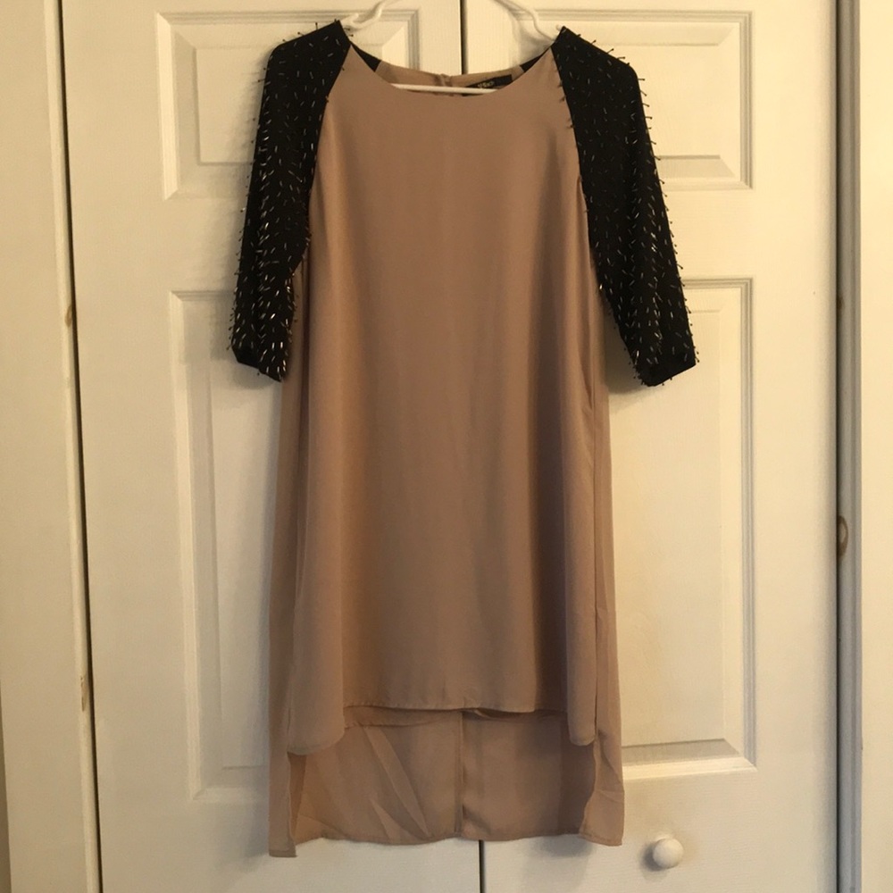 Shell party dress with beaded 3/4 length sleeves.